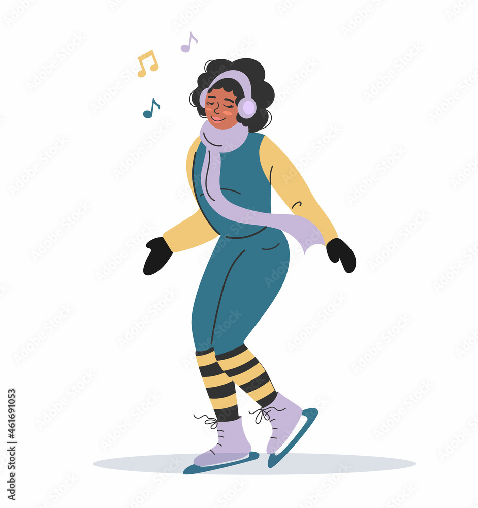 An African-American girl in warm winter clothes is skating and listening to music with headphones.
