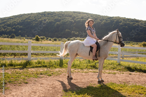 The woman restores her mental health by riding a horse © oksix