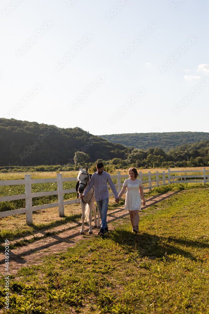 Couple walk at the ranch during summer day
