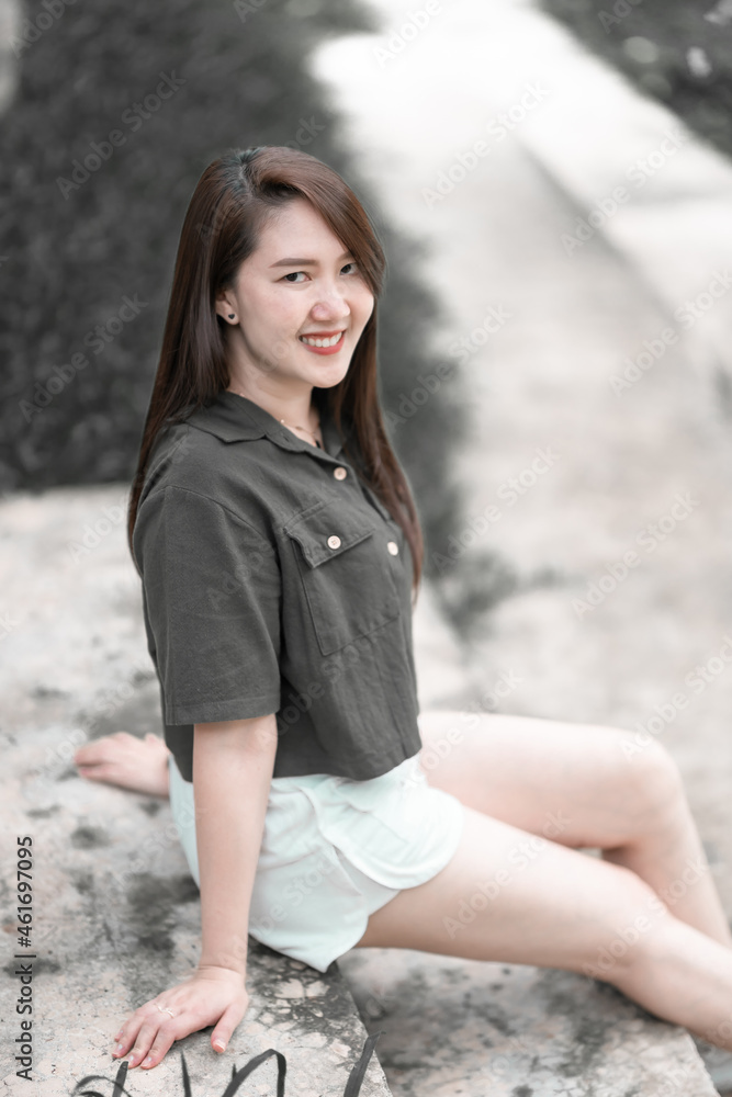a portrait of beautiful happy asian woman traveler wearing brownish green dress stylish hipster Summer sunny lifestyle on the street outdoors at sunny summer day in park background a portrait of beautiful happy asian woman traveler wearing brownish green dress stylish hipster Summer sunny lifestyle on the street outdoors at sunny summer day in park background