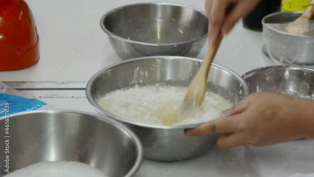 close up whisking butter , eggs and cream in bowl close up whisking butter , eggs and cream in bowl