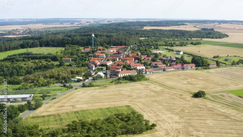 Aerial drone shot - a town surrounded by fields and forests in a rural area Aerial drone shot - a town surrounded by fields and forests in a rural area