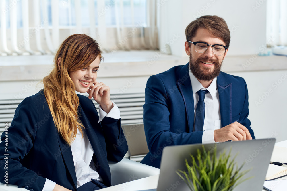 man and woman managers work together in front of laptop professionals technology man and woman managers work together in front of laptop professionals technology
