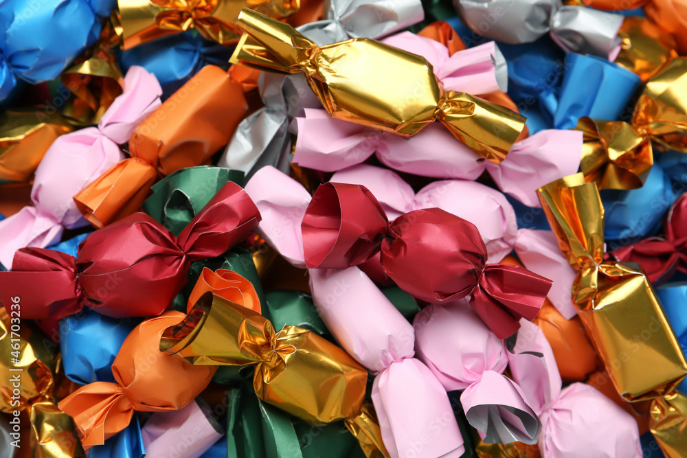 Many candies in colorful wrappers as background, closeup
