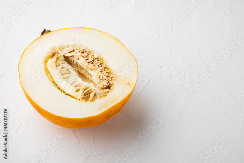 Half of cantaloupe melon, on white stone table background, with copy space for text