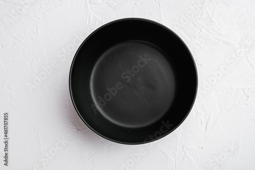 Black bowl, with copy space for text or food, with copy space for text or food, top view flat lay , on white stone table background