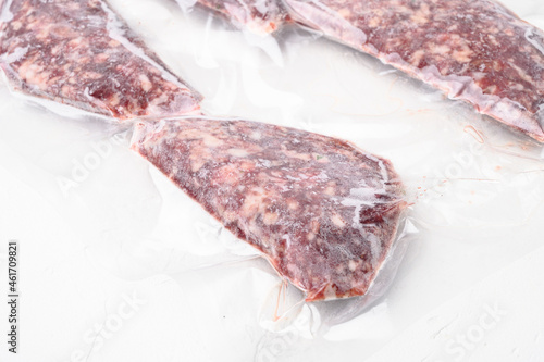 Vacuum beef or lamb mutton cutlet sealed airtight pack, on white stone table background