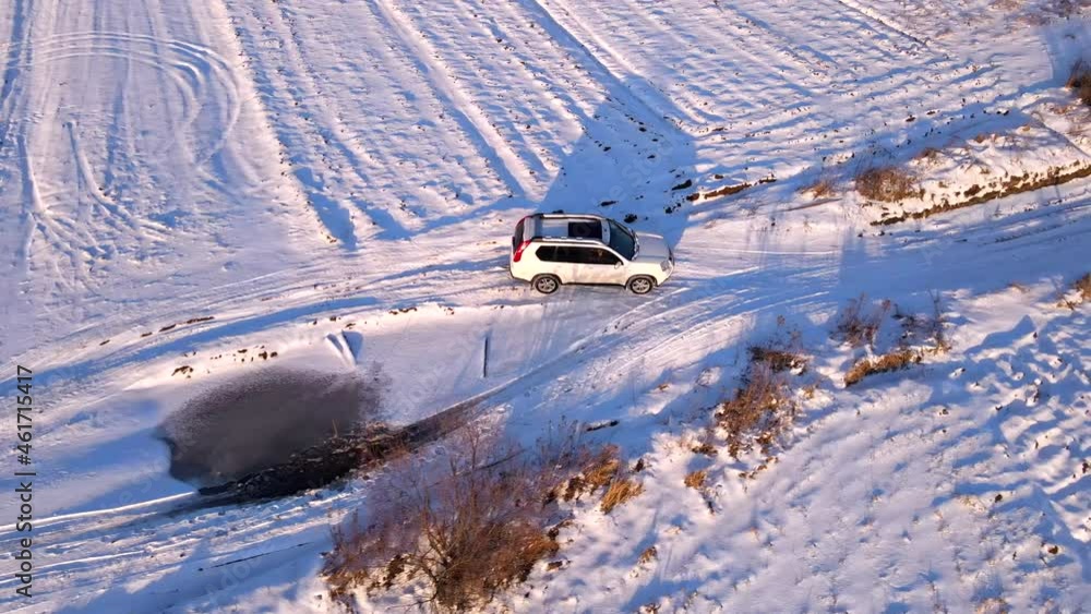 aerial view of suv car at snowed field road aerial view of suv car at snowed field road