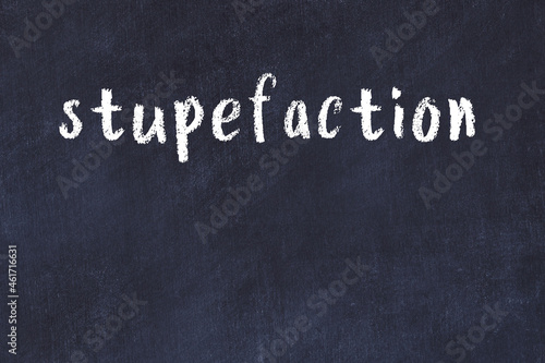 College chalk desk with the word stupefaction written on in