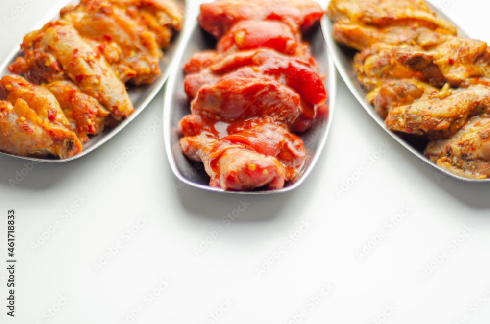 Three different set of the chicken wings with sriracha glaze, Caribbean marinade and Chinese glaze Three different set of the chicken wings with sriracha glaze, Caribbean marinade and Chinese glaze