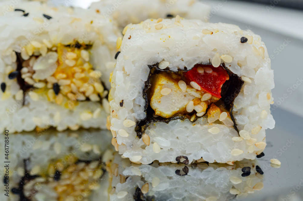 Closeup of katsu chicken and red pepper California roll, traditional Closeup of katsu chicken and red pepper California roll, traditional