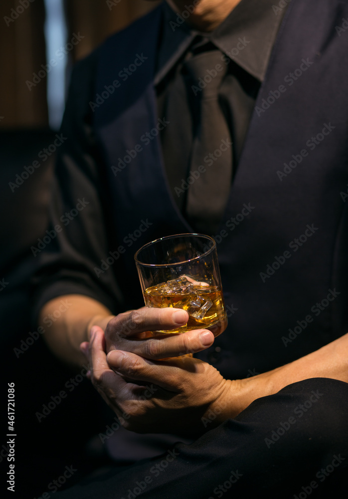 Businessmen in suits drinking whiskey