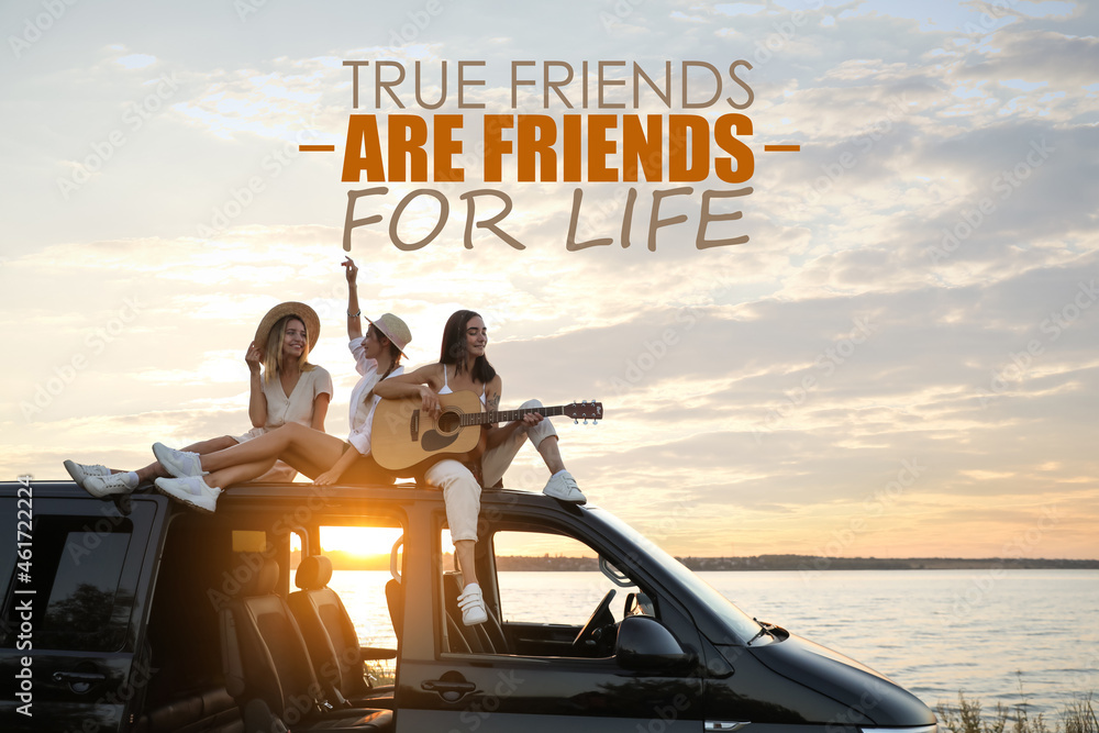 True Friends Are Friends For Life. Inspirational quote saying that truly friendship lasts for years. Text against view of girls having fun on car roof at sunset - obrazy, fototapety, plakaty 