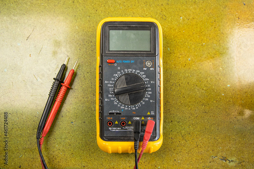 Multimeter with buttons and cables on table photo