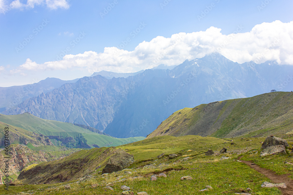Mountain landscape. View of the mountains, mountain valleys and clouds above them.