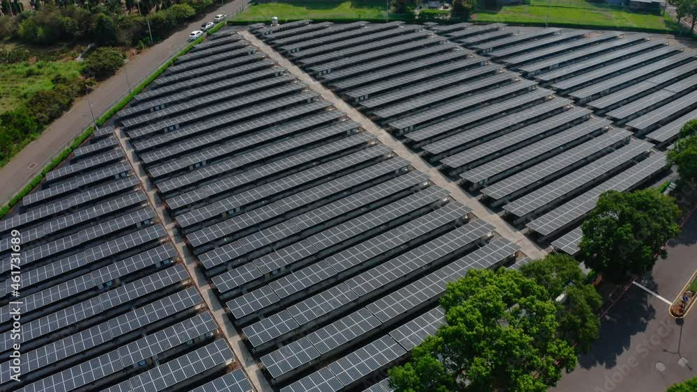 Aerial flyover large Solar Panels Farm with solar units in rural residential area - Cells producing energy with sunlight - Electrical Innovation - 4K shot Aerial flyover large Solar Panels Farm with solar units in rural residential area - Cells producing energy with sunlight - Electrical Innovation - 4K shot
