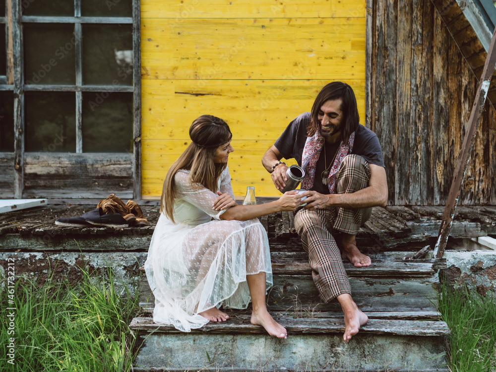 Hippie man sharing coffee with beautiful hippie girl