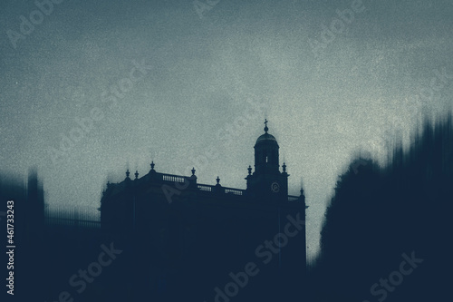 A spooky concept. Of looking up at the silhouette of a mysterious church with a grunge, texture edit.