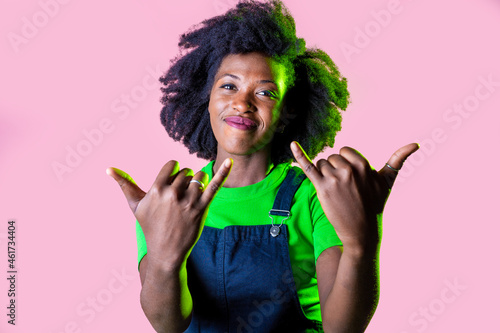 Rock'n'roll young black woman isolated background gesturing having fun smiling happy