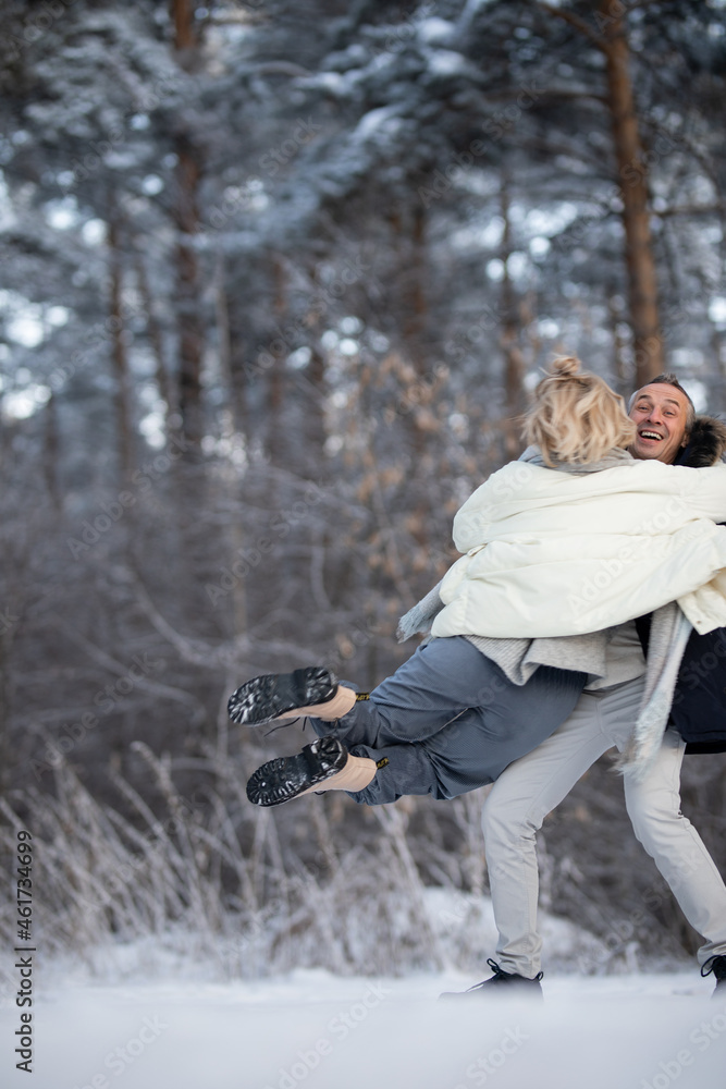 Obraz premium adult man and woman hugging on the street in winter