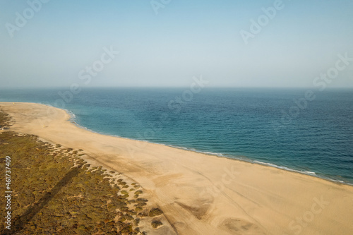 Sandy beach near blue sea