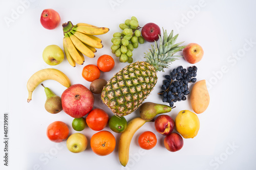 Mix of fresh juicy colorful exotic tropical fruits on white background top view