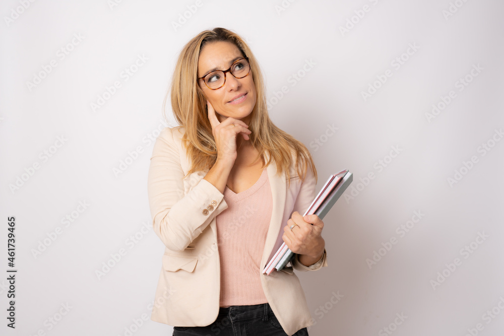 Cheerful young business woman isolated on white background studio. Achievement career wealth business concept. Hold notebooks, looking aside. Cheerful young business woman isolated on white background studio. Achievement career wealth business concept. Hold notebooks, looking aside.