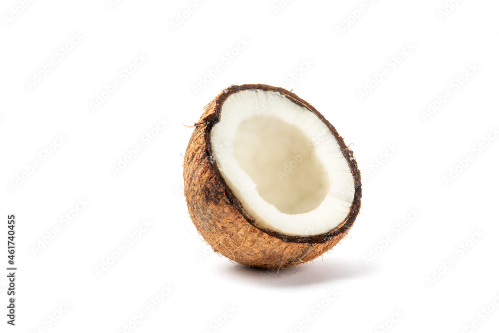 half of a ripe coconut broken open to reveal the sweet flesh inside isolated on white