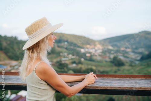 Portrait of a young woman in straw hat at viewpoint