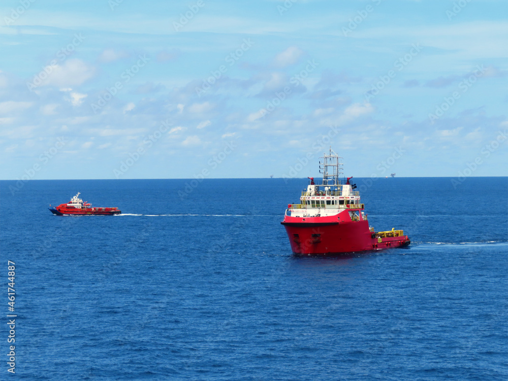 Supply boat transfer the cargo for supporting oil and gas industry and moving cargo from the boat to the platform. Boat is waiting transfer cargo and crews to platform. Supply boat transfer the cargo for supporting oil and gas industry and moving cargo from the boat to the platform. Boat is waiting transfer cargo and crews to platform.