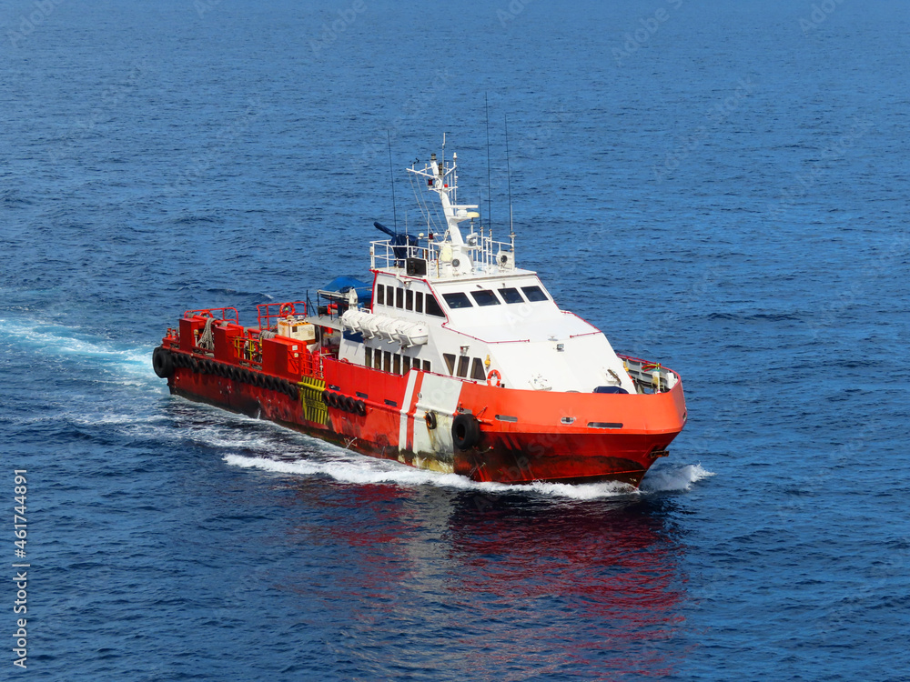Supply boat transfer the cargo for supporting oil and gas industry and moving cargo from the boat to the platform. Boat is waiting transfer cargo and crews to platform. Supply boat transfer the cargo for supporting oil and gas industry and moving cargo from the boat to the platform. Boat is waiting transfer cargo and crews to platform.