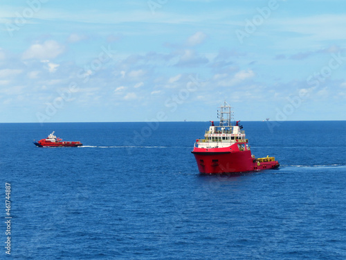 Supply boat transfer the cargo for supporting oil and gas industry and moving cargo from the boat to the platform. Boat is waiting transfer cargo and crews to platform.  © chanjaok1