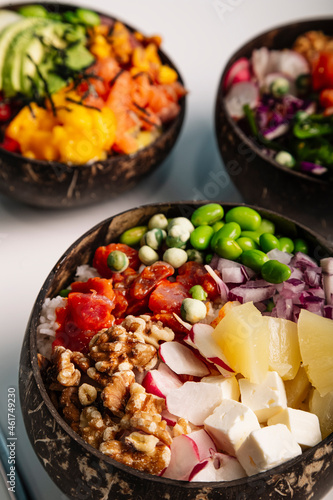 Vertical image close up of Poke bowl with fish, rice and fresh vegetables