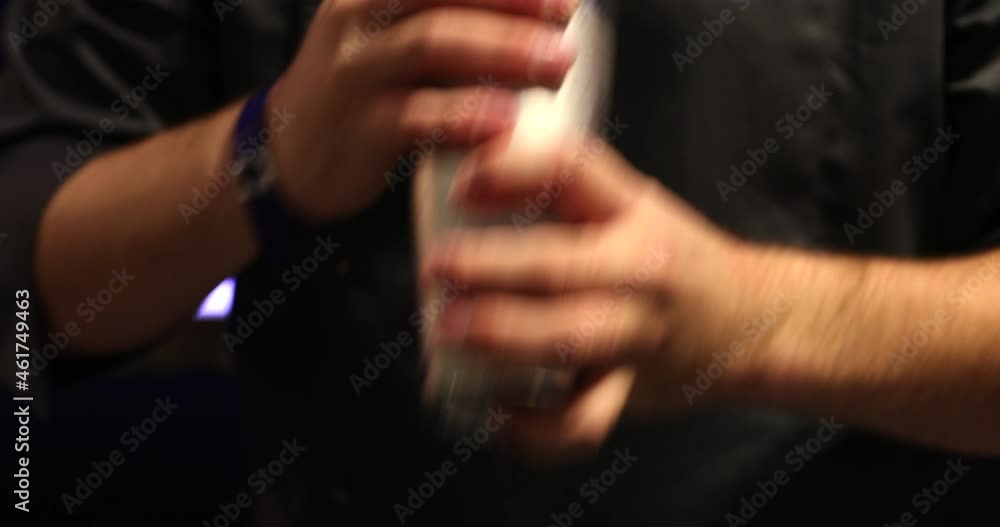 The bartender makes a cocktail with a shaker. The bartender makes a cocktail with a shaker.