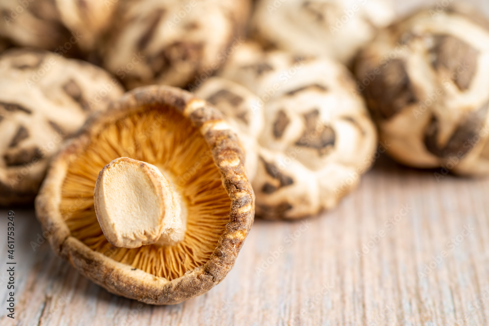 Dried shiitake mushroom on wooden background. Healthy food. Dried shiitake mushroom on wooden background. Healthy food.