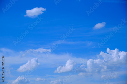 White fluffy clouds in the blue sky in clear weather in summer  winter  spring  nature creates a beautiful background on earth.