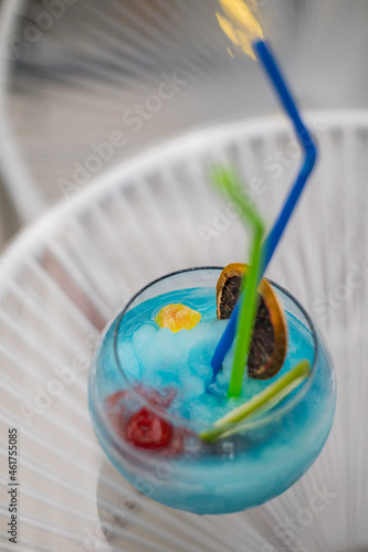 Close up of a blue cocktail on a glass with white lines