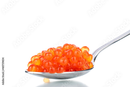 Lightly salted red chum salmon caviar with a metal spoon, close-up, isolated on white.