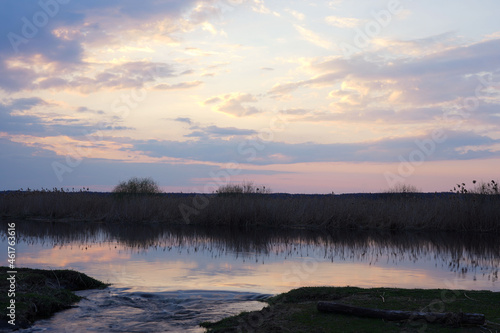 Biebrza River after sunset, reeds, sky and clouds