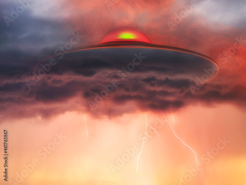 flying saucer emerging from the clouds