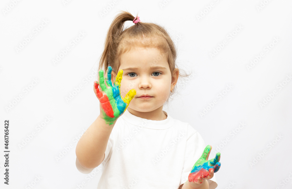 Cute girl showing her hands painted in bright colors, isolated over white Cute girl showing her hands painted in bright colors, isolated over white