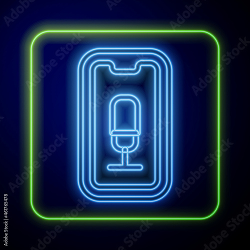 Glowing neon Mobile recording icon isolated on blue background. Mobile phone with microphone. Voice recorder app smartphone interface. Vector