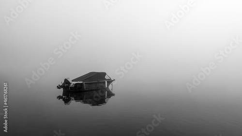 sloop on the lake at morning fog