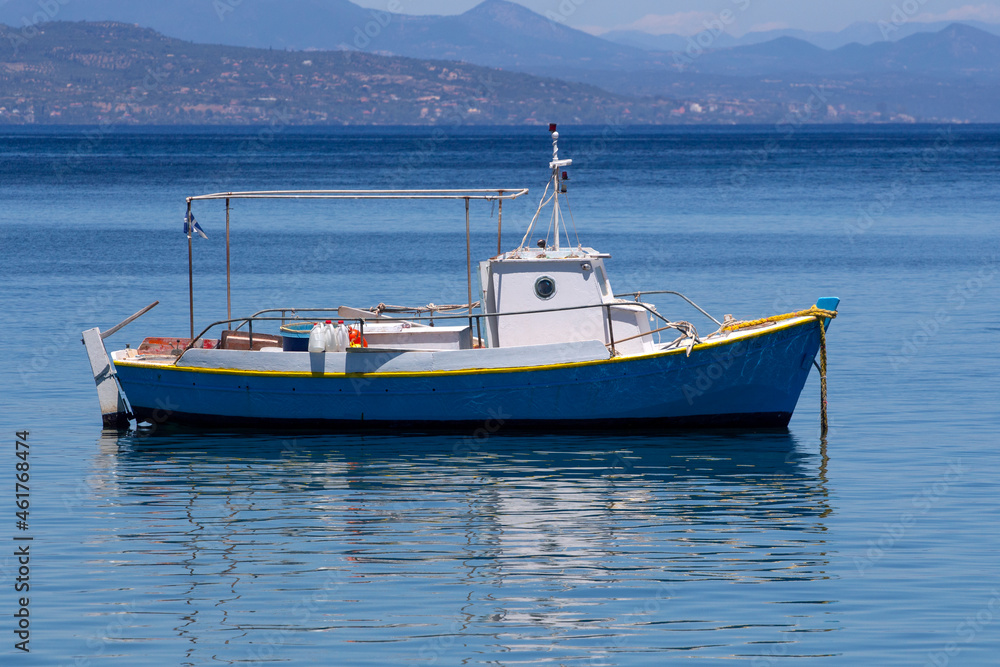 fishing boat in the port of Koroni (a coastal town in Messenia, Peloponnese, Greece). Sunny summer day fishing boat in the port of Koroni (a coastal town in Messenia, Peloponnese, Greece). Sunny summer day