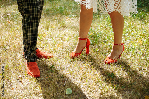 the newlyweds are dressed in shoes of the same red color