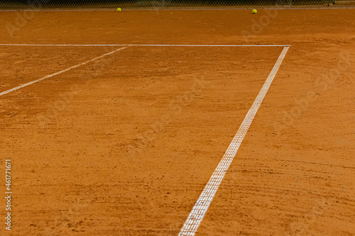 Corner of the ground tennis court with white lines