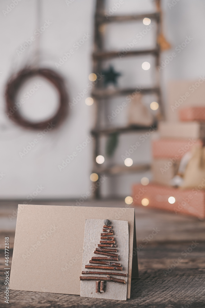 Close up creative sustainable eco Christmas tree handmade of wooden branches on the background gift boxes. Zero waste Christmas concept. High quality photo Close up creative sustainable eco Christmas tree handmade of wooden branches on the background gift boxes. Zero waste Christmas concept. High quality photo