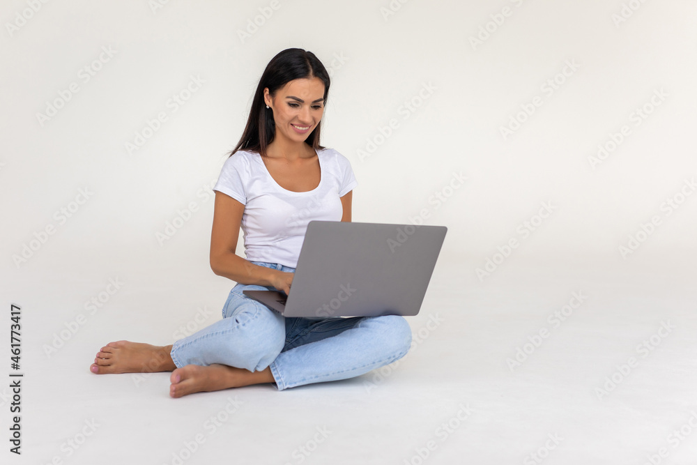 Young woman working on a laptop isolated over a white backgorund Young woman working on a laptop isolated over a white backgorund