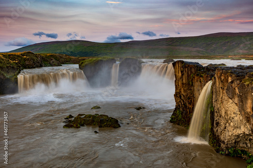 dramatic sky during sunset in the powerful Godafoss waterfall in Iceland.