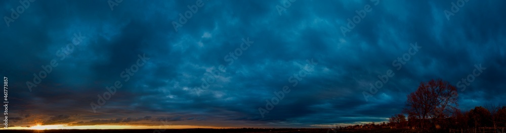 Panorama of dawn fire in the sky above the natural pasture. Golden red clouds just before sunrise. Picturesque landscape at sunrise. Beauty in nature Panorama of dawn fire in the sky above the natural pasture. Golden red clouds just before sunrise. Picturesque landscape at sunrise. Beauty in nature